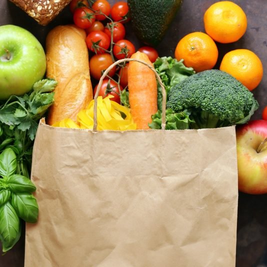 paper shopping bag full of food